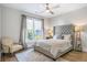 Comfortable bedroom with a tufted headboard, neutral colors, and plenty of natural light at 175 Stovall Se St, Atlanta, GA 30316