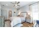 Charming bedroom with a ceiling fan, hardwood floors, neutral colors, bright windows, and comfy furniture at 175 Stovall Se St, Atlanta, GA 30316