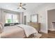 Well-lit bedroom featuring hardwood floors, a ceiling fan, dresser, and an inviting black sofa at 175 Stovall Se St, Atlanta, GA 30316