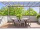 Outdoor dining area on the rooftop deck featuring a wood pergola and seating for six at 175 Stovall Se St, Atlanta, GA 30316