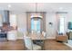 Open concept with a dining area featuring a long wooden table and modern chandelier at 175 Stovall Se St, Atlanta, GA 30316