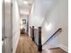 Hallway with wood floors, wooden banister, and neutral paint at 175 Stovall Se St, Atlanta, GA 30316