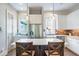 Bright kitchen with white cabinets, stainless steel appliances, brick backsplash and an island with bar stool seating at 175 Stovall Se St, Atlanta, GA 30316