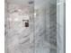 Close up of the modern glass shower featuring marble tile walls with a built-in niche at 175 Stovall Se St, Atlanta, GA 30316