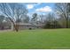 Expansive backyard with lush green grass and mature trees, perfect for outdoor activities at 2017 Allwood Ct, Lawrenceville, GA 30044