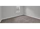 Cozy bedroom features neutral carpet, fresh paint, baseboard trim and bright window with view to yard at 2017 Allwood Ct, Lawrenceville, GA 30044