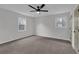 This bedroom boasts carpeted flooring, neutral walls, dual windows and closet with updated doors at 2017 Allwood Ct, Lawrenceville, GA 30044