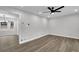 Open-concept living area with new hardwood floors, recessed lights, neutral paint and view into kitchen at 2017 Allwood Ct, Lawrenceville, GA 30044