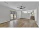 Bright living room with hardwood flooring, neutral paint, access to backyard and view into updated kitchen at 2017 Allwood Ct, Lawrenceville, GA 30044