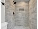 This shower features attractive stone style tile and an updated shower head at 2017 Allwood Ct, Lawrenceville, GA 30044