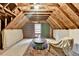 Unfinished attic space with exposed beams, some drywall, and a rug at 2130 Monticello Pl, Lawrenceville, GA 30043
