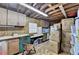 Basement with cabinets, countertops, exposed ceiling and stacked moving boxes at 2130 Monticello Pl, Lawrenceville, GA 30043
