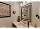 Cozy powder room featuring vanity, framed mirror, and decorative wall art at 2130 Monticello Pl, Lawrenceville, GA 30043