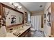 Neutral bathroom with a long vanity, single sink, large mirror, and decorative painting at 2130 Monticello Pl, Lawrenceville, GA 30043