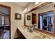 Bright bathroom features double sinks, a large mirror, and decorative accents; doorway to bedroom visible at 2130 Monticello Pl, Lawrenceville, GA 30043