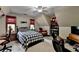 This bedroom features a cozy black and white bed, multiple windows and a ceiling fan at 2130 Monticello Pl, Lawrenceville, GA 30043