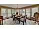 Bright dining area with many windows, wood floors and decorative chandelier at 2130 Monticello Pl, Lawrenceville, GA 30043