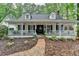 Charming white home with a welcoming front porch and landscaped front yard at 2130 Monticello Pl, Lawrenceville, GA 30043