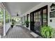 Inviting front porch with ceiling fan, wicker furniture, and decorative plants at 2130 Monticello Pl, Lawrenceville, GA 30043