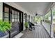 Charming front porch with a ceiling fan, a black front door, and a swing at 2130 Monticello Pl, Lawrenceville, GA 30043
