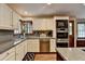 Well-lit kitchen featuring granite countertops, stainless steel appliances, and white cabinetry at 2130 Monticello Pl, Lawrenceville, GA 30043
