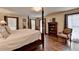 Spacious main bedroom featuring a four-poster bed, hardwood floors, and lots of natural light at 2130 Monticello Pl, Lawrenceville, GA 30043