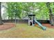 Backyard play structure has a tower with slide, swing set and climbing bars at 2130 Monticello Pl, Lawrenceville, GA 30043
