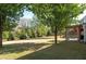 A vast backyard featuring a lush lawn, mature trees, and a covered patio, providing ample space for recreation at 630 Bluff Oak Ct, Roswell, GA 30076