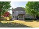 Expansive backyard showcasing a large lawn, a covered patio, and mature trees for added privacy at 630 Bluff Oak Ct, Roswell, GA 30076