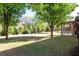 A vast backyard featuring a lush lawn, mature trees, and a covered patio, providing ample space for recreation at 630 Bluff Oak Ct, Roswell, GA 30076
