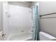 Cozy bathroom featuring a bathtub with a shower, complemented by white tiles and modern fixtures at 630 Bluff Oak Ct, Roswell, GA 30076