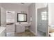 Bright bathroom with a single vanity and doorway to the water closet and main bedroom at 630 Bluff Oak Ct, Roswell, GA 30076