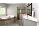 Bright bathroom with a soaking tub, glass shower, and double sink vanity at 630 Bluff Oak Ct, Roswell, GA 30076