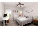 Bedroom with neutral walls, carpet floors, ceiling fan, a desk and large windows at 630 Bluff Oak Ct, Roswell, GA 30076