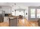 Bright dining area with large windows, hardwood floors, and modern pendant lighting at 630 Bluff Oak Ct, Roswell, GA 30076