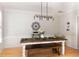 Elegant dining room with rustic table, bench seating, and stylish light fixture at 630 Bluff Oak Ct, Roswell, GA 30076