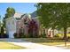 Charming brick two-story home with manicured lawn and a driveway leading to a two-car garage at 630 Bluff Oak Ct, Roswell, GA 30076
