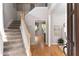 Bright foyer with staircase and hardwood floors, creating a welcoming entrance at 630 Bluff Oak Ct, Roswell, GA 30076