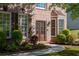 Elegant home entrance featuring a double door with glass insets, decorative shutters and manicured landscaping at 630 Bluff Oak Ct, Roswell, GA 30076