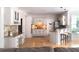 Bright kitchen with hardwood floors, light cabinetry, bar seating, and modern appliances at 630 Bluff Oak Ct, Roswell, GA 30076