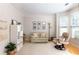 Cozy living room featuring plush seating, built-in shelving and a bay window offering natural light at 630 Bluff Oak Ct, Roswell, GA 30076