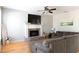 Cozy living room featuring a brick fireplace, comfortable seating and natural light at 630 Bluff Oak Ct, Roswell, GA 30076