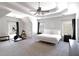 Spacious main bedroom with a tray ceiling, carpeted floors, and large windows at 630 Bluff Oak Ct, Roswell, GA 30076