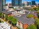 Aerial view of a brick building with a rooftop pool and upscale apartments in a lively downtown area at 850 Piedmont Ne Ave # 2509, Atlanta, GA 30308