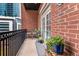 Cozy outdoor balcony space with exposed brick and French doors at 850 Piedmont Ne Ave # 2509, Atlanta, GA 30308