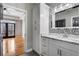 Bathroom vanity with marble countertops, white cabinets, and access to the bedroom at 850 Piedmont Ne Ave # 2509, Atlanta, GA 30308