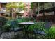 Charming courtyard featuring a table and chairs surrounded by vibrant greenery, perfect for relaxation at 850 Piedmont Ne Ave # 2509, Atlanta, GA 30308