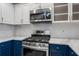 Close up of kitchen featuring stainless steel gas range, microwave, and marble counters at 850 Piedmont Ne Ave # 2509, Atlanta, GA 30308