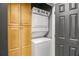 Laundry closet with stackable washer and dryer and custom storage cabinets at 850 Piedmont Ne Ave # 2509, Atlanta, GA 30308