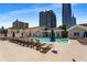 Beautiful community pool surrounded by lounge chairs and umbrellas, set against a backdrop of city skyscrapers at 850 Piedmont Ne Ave # 2509, Atlanta, GA 30308